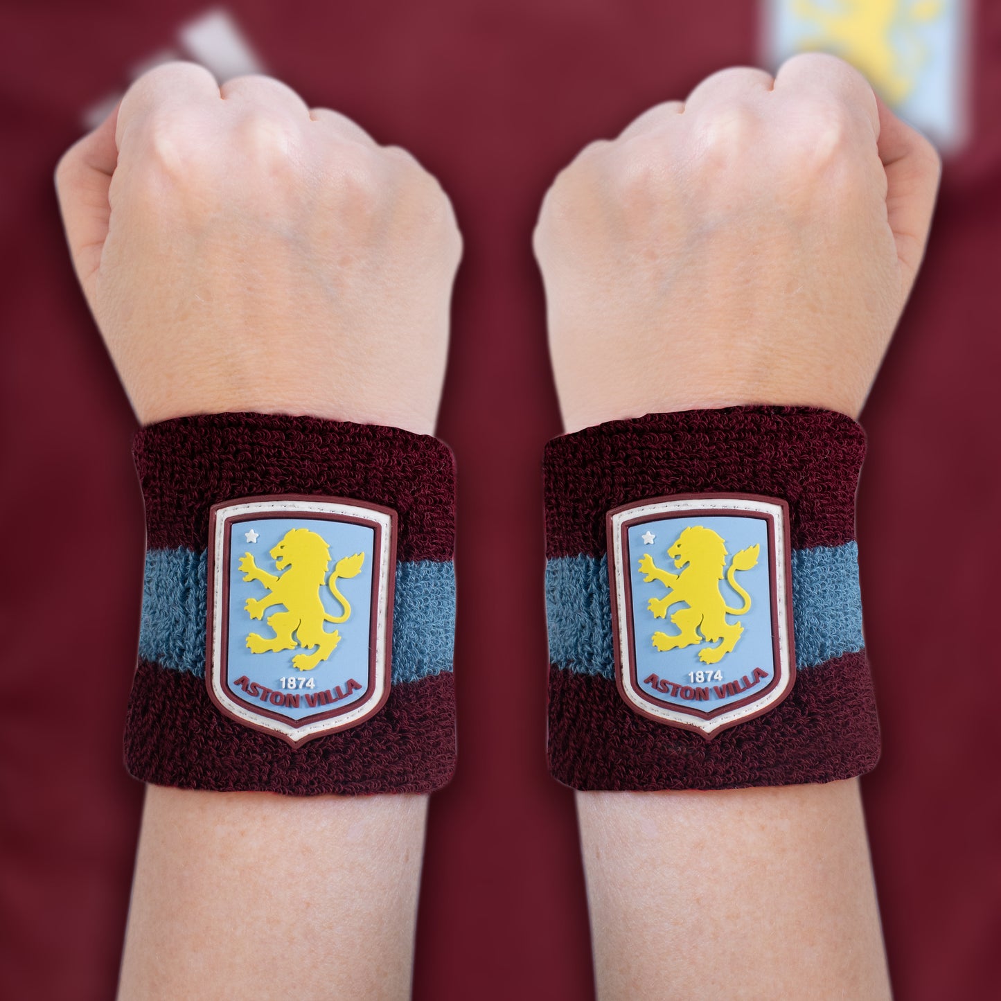 Officially licensed Aston villa sweat bands by hy-pro sports being worn on both wriest with a red burgundy background