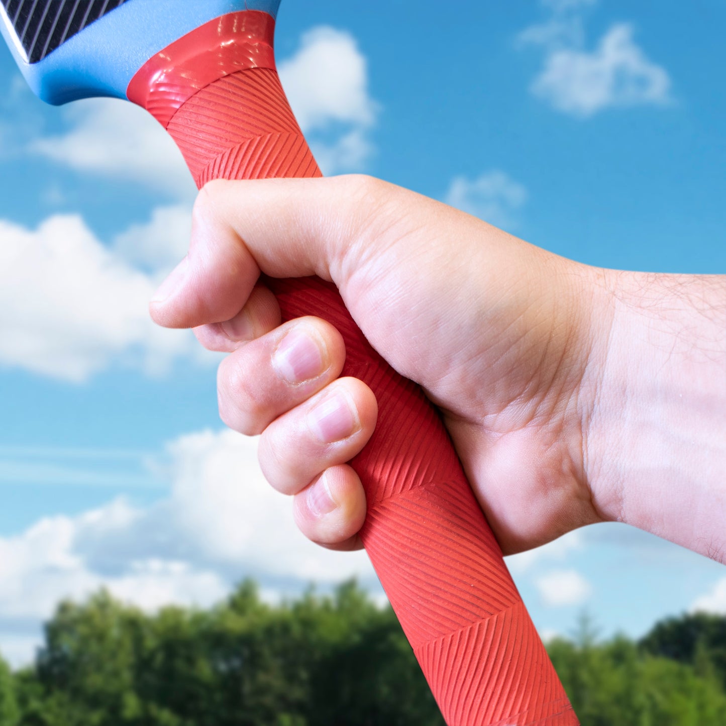 Close up of the soft grip handle on the Hy-Pro Cricket Bat & Ball in Blue and red in an outside setting