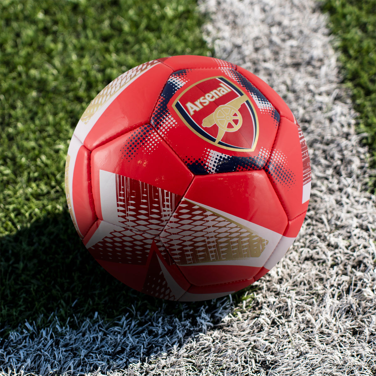 Close up angle of the Arsenal F.C. Football - Size 3, Spiral Design on a grass pitch