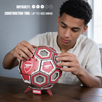 Boy putting together the Arsenal wooden football construction