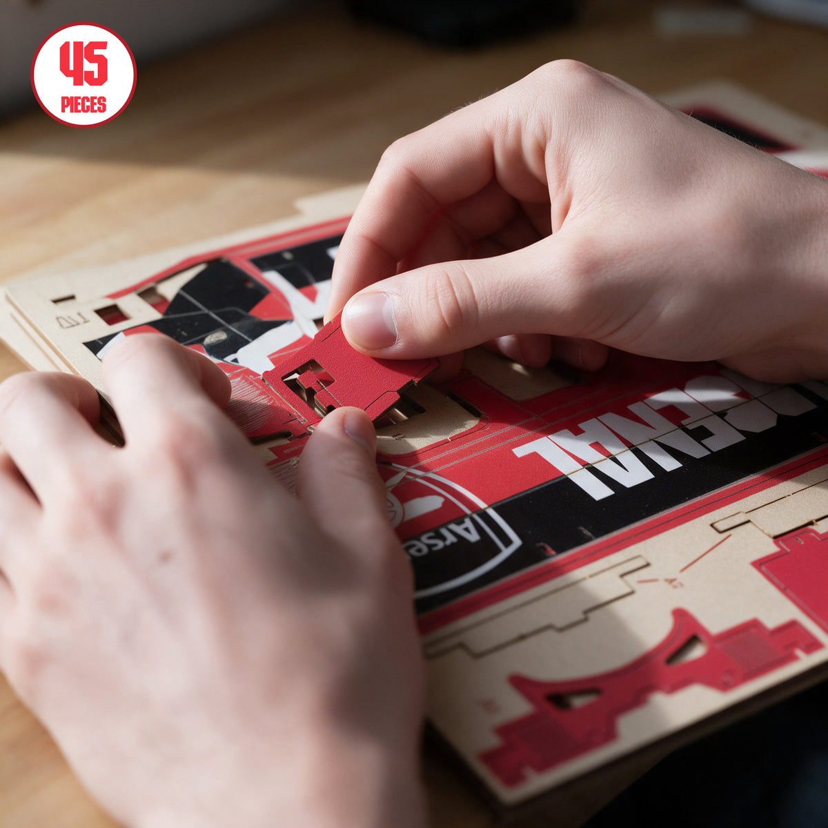 Close up of hands building the 45 piece Arsenal team bus construction