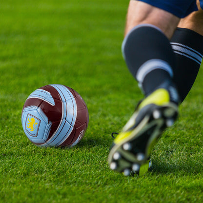 Hy-Pro Officially Licensed Aston Villa F.C. Cyclone Football being used in a grass field. Image show football boots running towards the ball