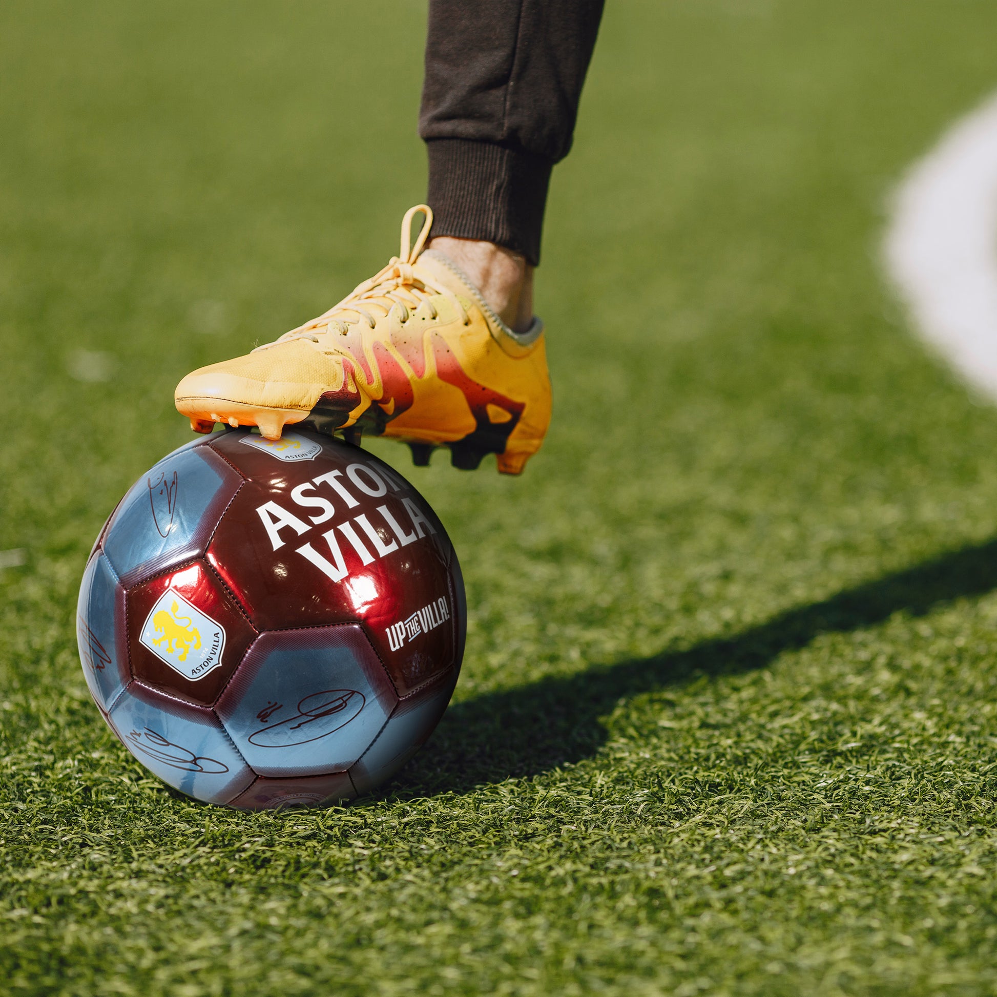 Officially licensed Aston Villa 5 size metallic football being used on a grass pitch 