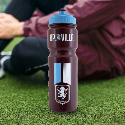 Officially licensed Aston Villa water bottle by Hy-Pro Sports on a grass itch in front of a player in burgundy jacket