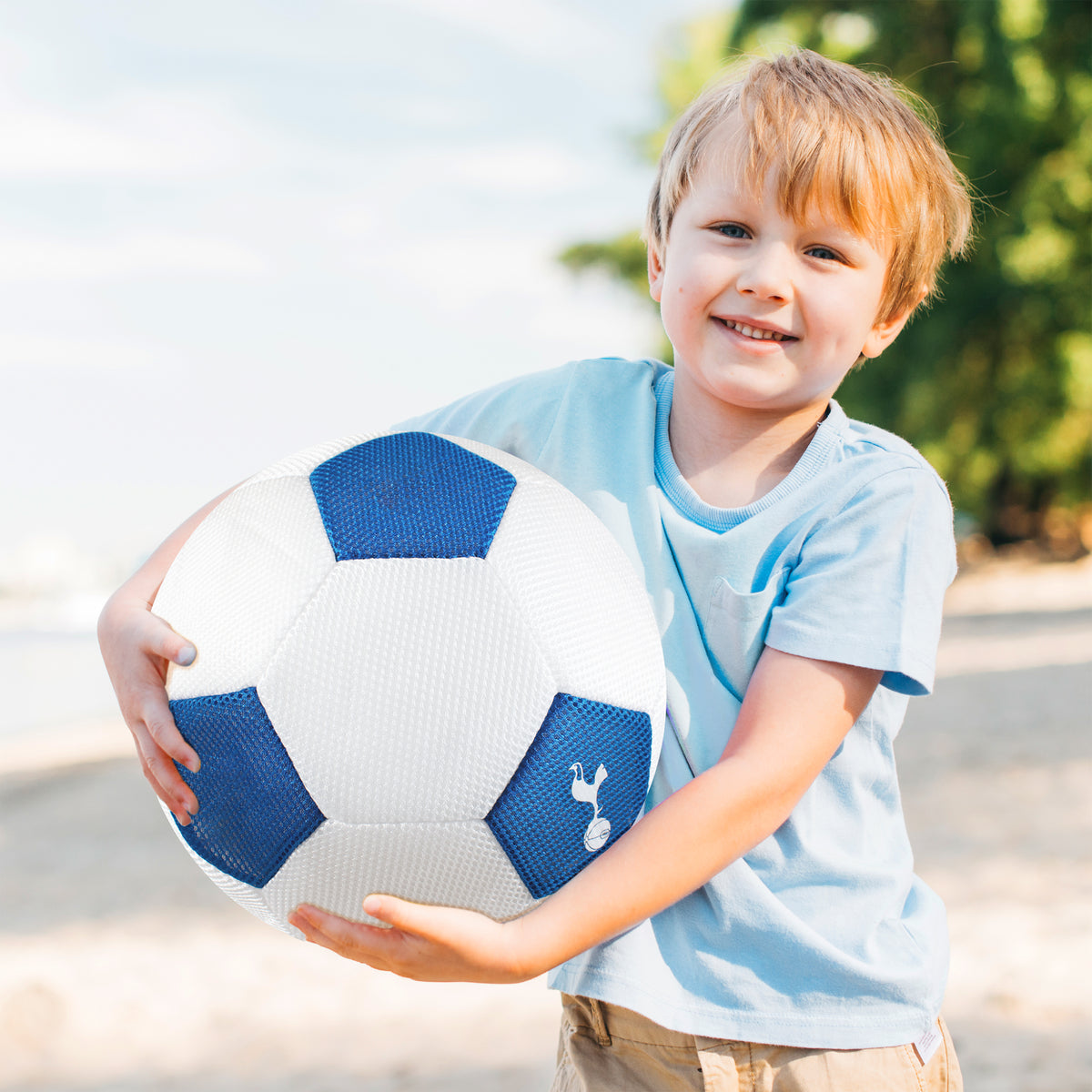 Tottenham Hotspur Giant 14in Mesh Ball being held by little boy on the beach 