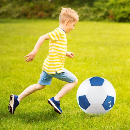 Tottenham Hotspur Giant 14in Mesh Ball being kicked across a grass field by a little boy