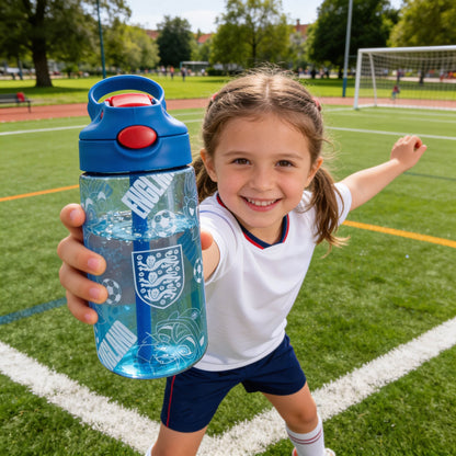 Young girl holding OFFICIALLY LICENSED ENGLAND WATER BOOTTLE WITH KID FRIENDLY PRINT IN BLUE ON A GRASS FOOTBALL PITCH