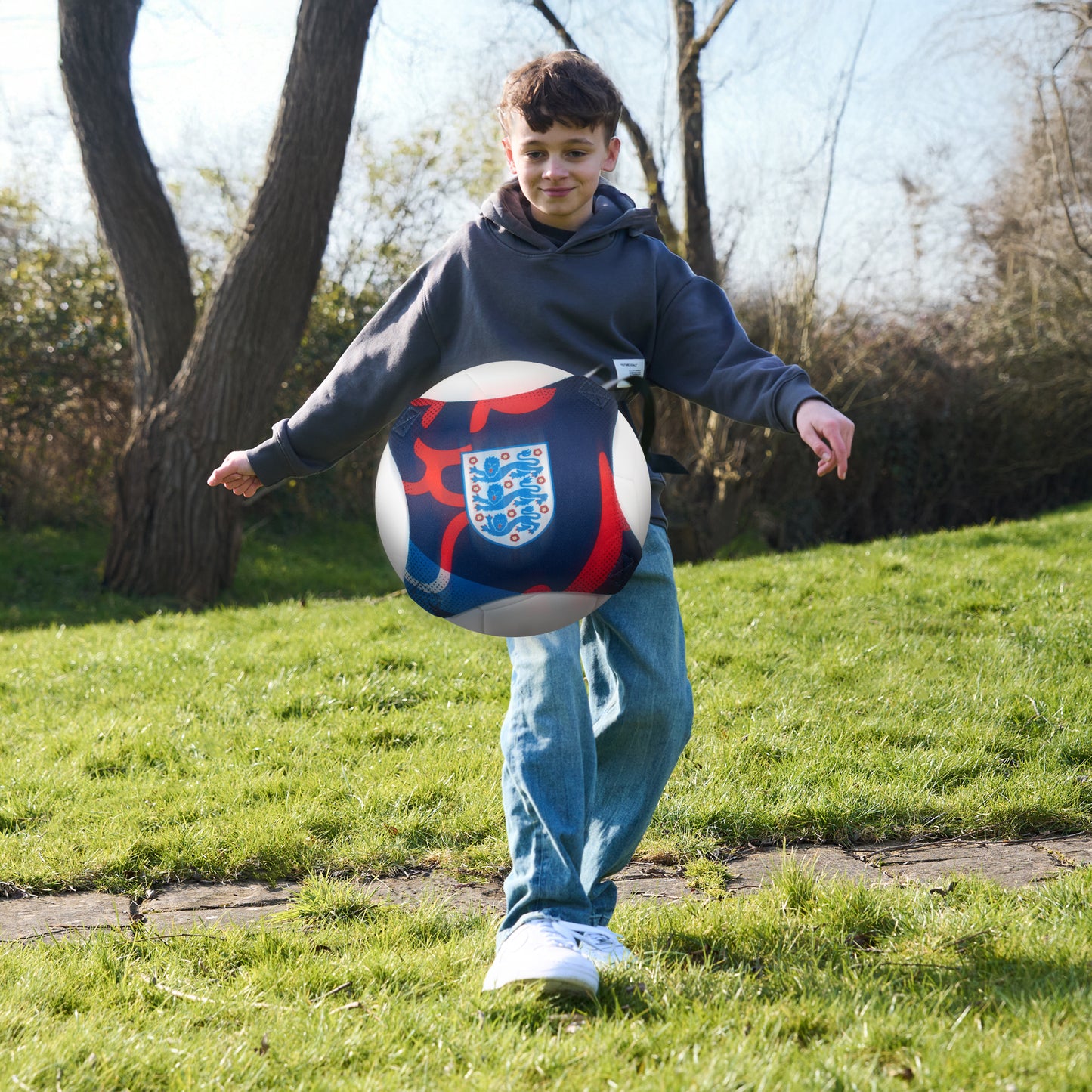 Officially licensed England 3 lions skill trainer being kicked towards camera whilst being worn by a young boy