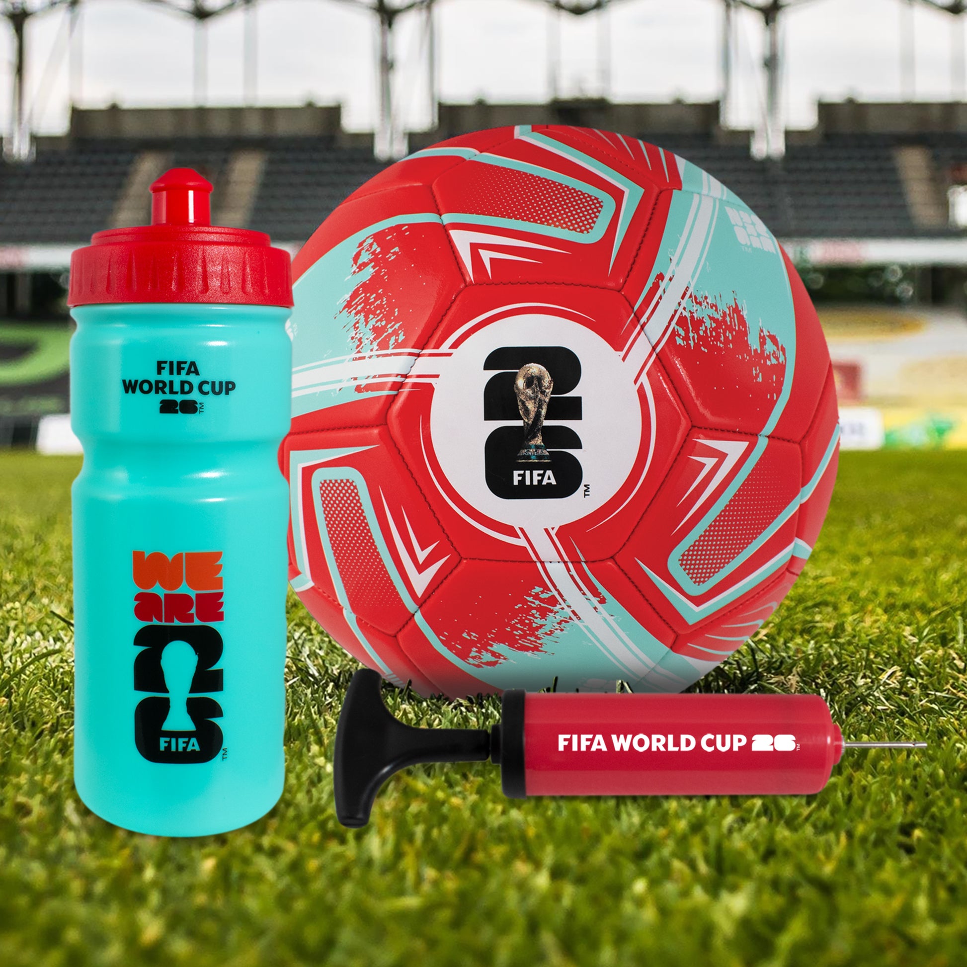 FIFA WORLD CUP 2026 FOOTBALL GIFT SET WITH BALL, PUMP AND BOTTLE ON A GRASS FOOTBALL FIELD