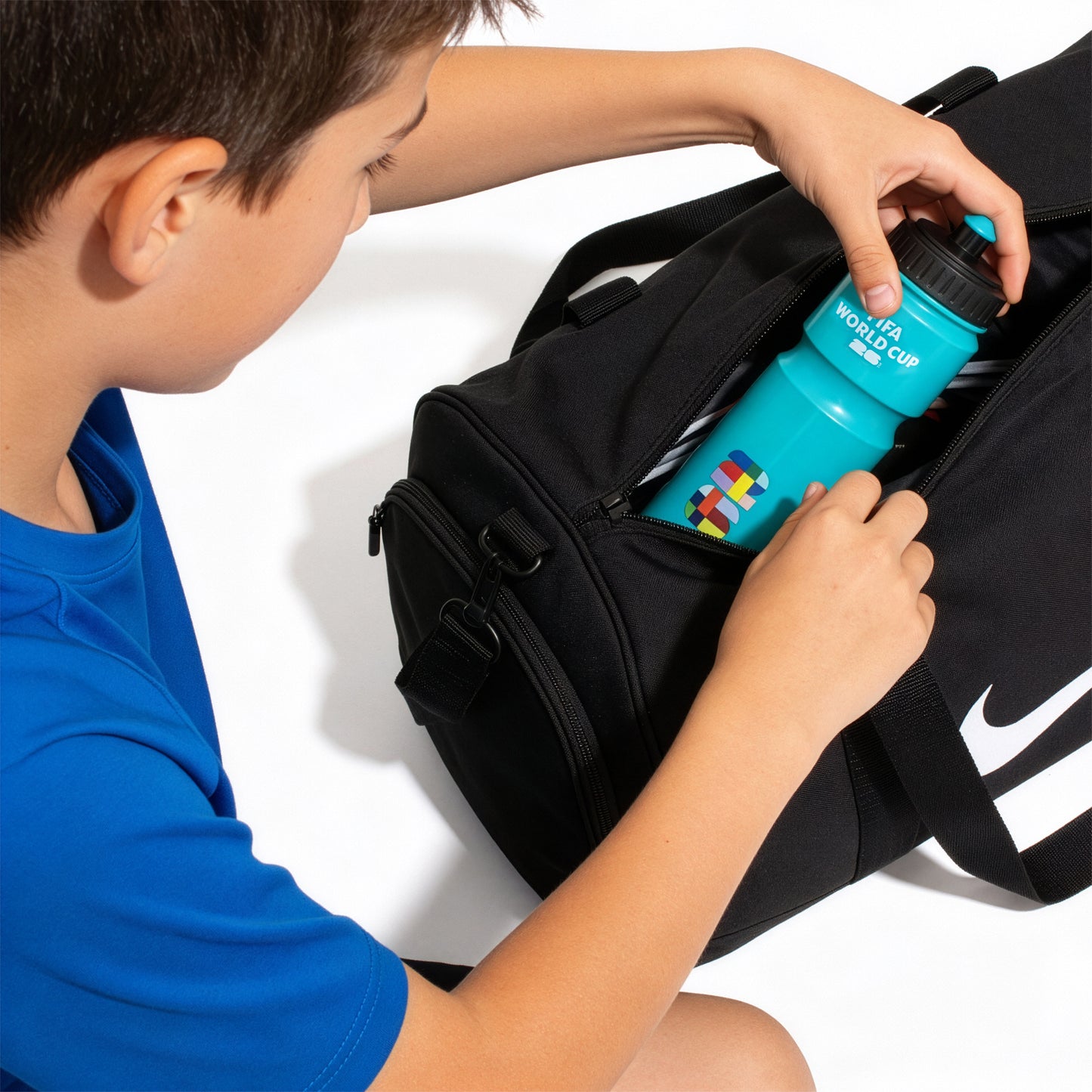 FIFA WORLD CUP 2026 WATER BOTTLE IN AQUA WITH SPORTS CAP BEING PLACED INTO A SPORTS BAG