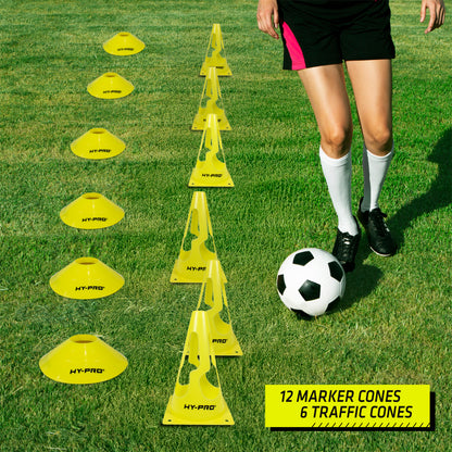 Hy-Pro marker cones and training traffic cones lined up next to a football layer on a grass background. Perfect for agility drills.