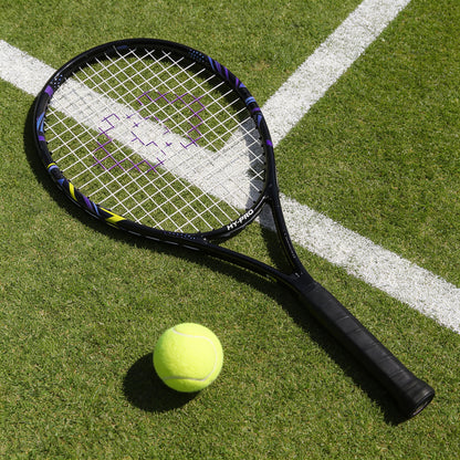 Tennis racket by hy-pro sports in blue and yellow on a tennis court next to a tennis ball