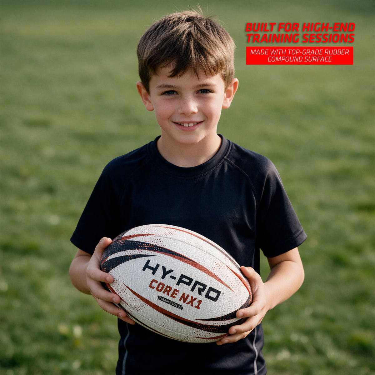Hy-Pro Core NX1 Rugby Training Ball being held by a young boy on a grass field with copy reading ' BUILT FOR HIGH-END TRAINING SESSIONS'