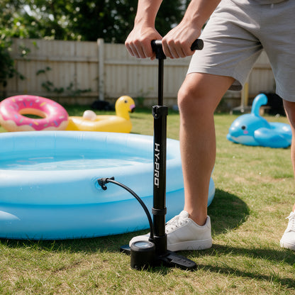 Black Hy-Pro pump being used in a garden to inflate a paddling pool