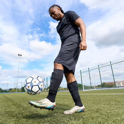 FIFA certified training ball being kicked up into the air by a football player on a football pitch