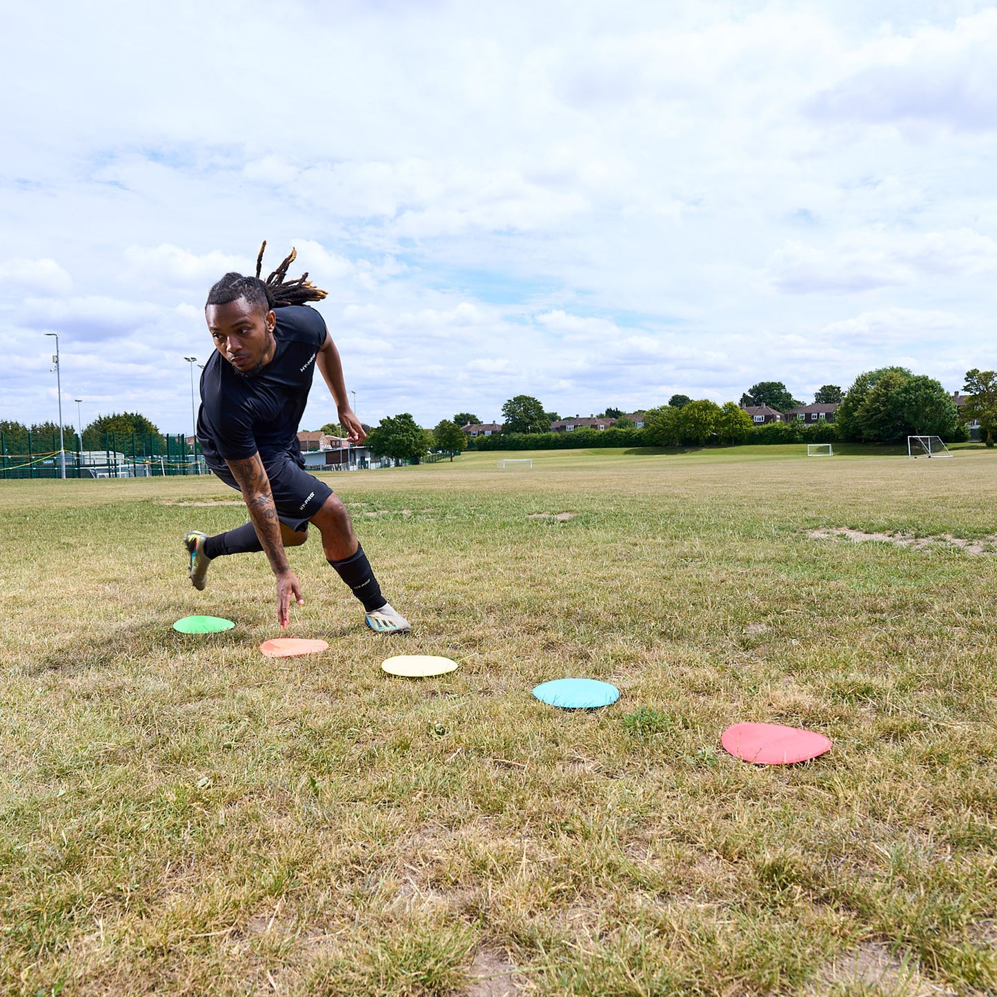 Flat floor Markers with HY-PRO branding being used in a grass field for agility training
