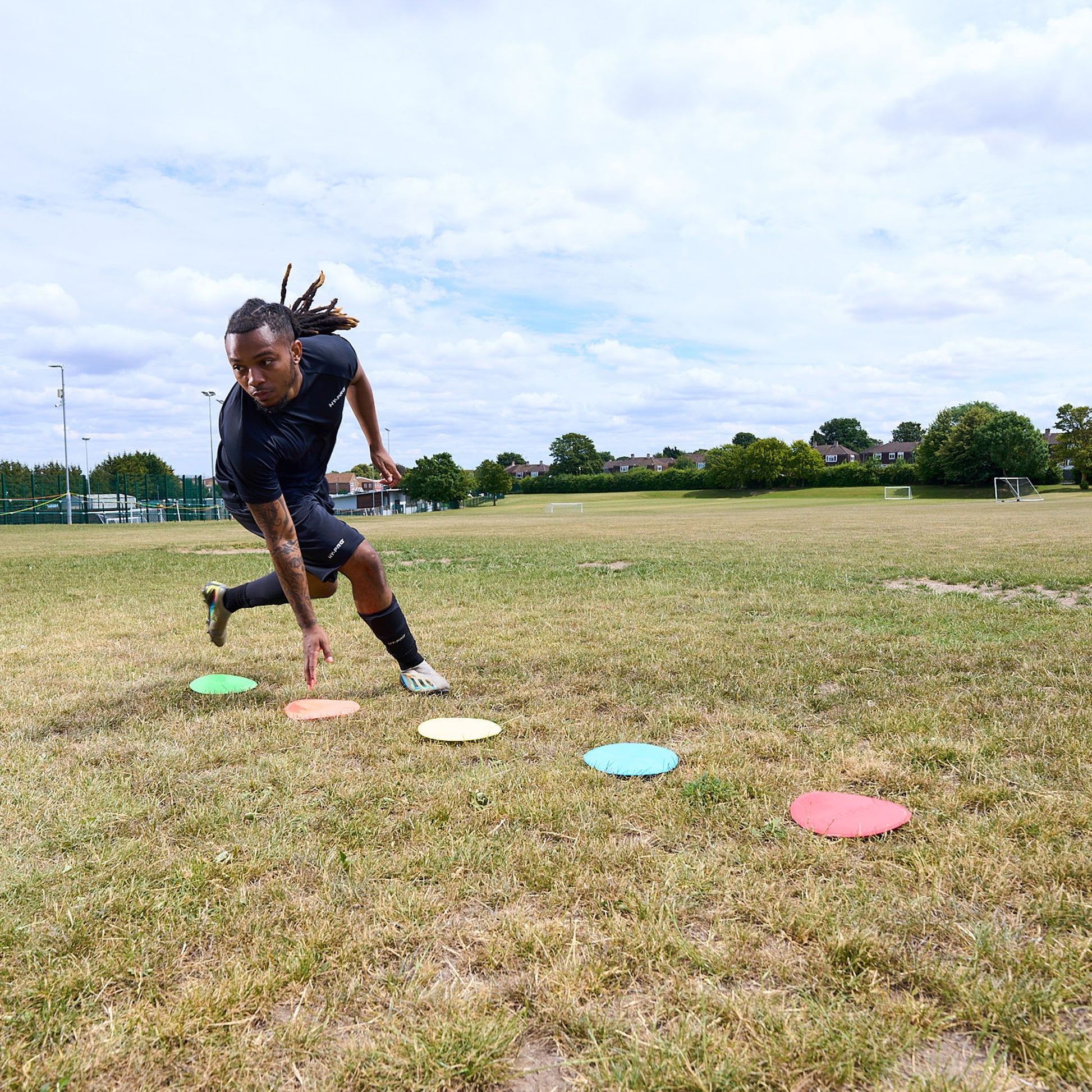Flat floor Markers with HY-PRO branding being used in a grass field for agility training