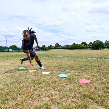 Flat floor Markers with HY-PRO branding being used in a grass field for agility training