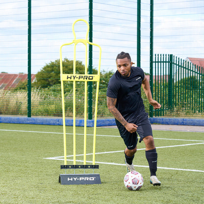 Hy-Pro sports rubber base and defender dummy on an Astroturf pitch while a player trains
