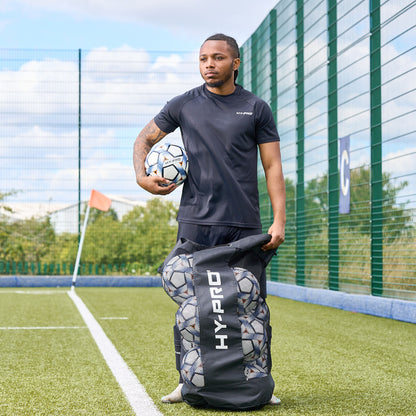 Hy-Pro Sports Jumbo Ball bag in black on a football pitch with a player taking out balls
