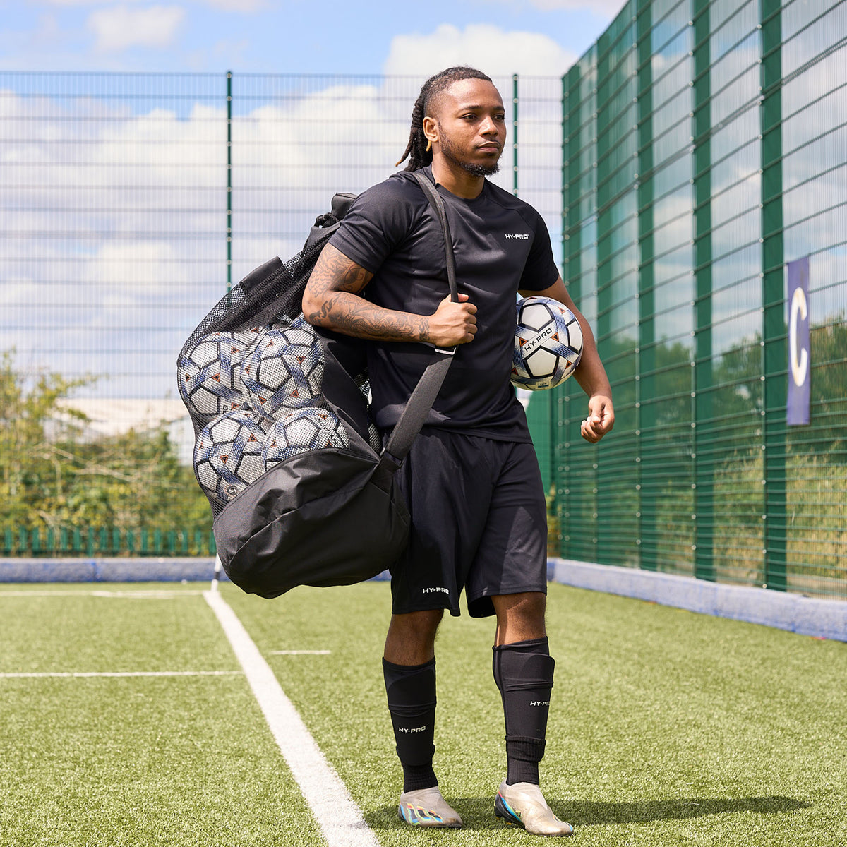 Front view of Hy-Pro Sports Jumbo Ball bag being carried across a football pitch by a player