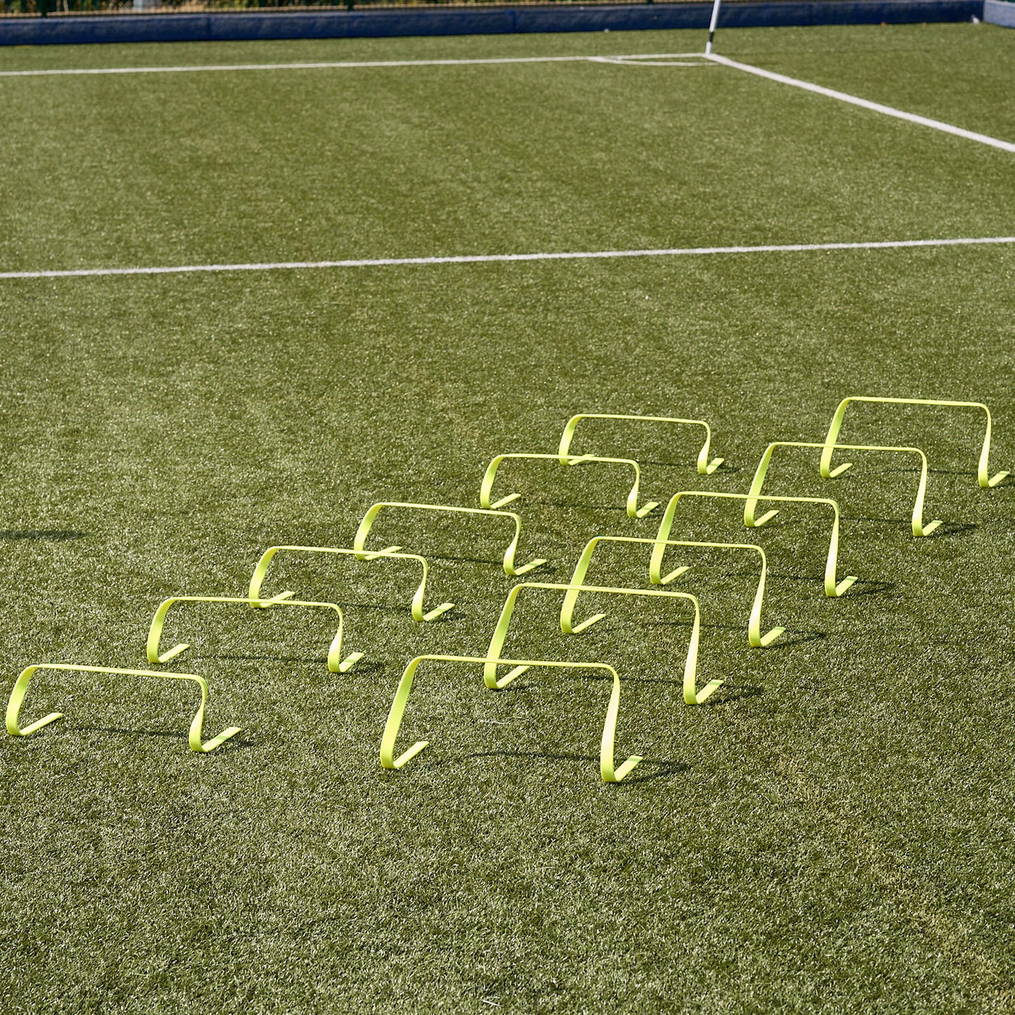 Hy-Pro Sports flat agility hurdles lined up side by side on an Astroturf pitch