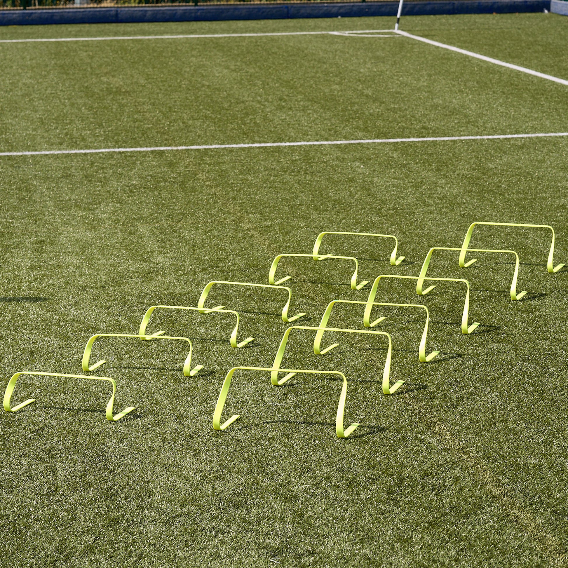 Hy-Pro Sports flat agility hurdles lined up side by side on an Astroturf pitch