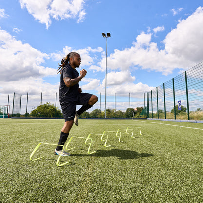 In action shot of a football player using the hy-pro sports yellow agility hurdles