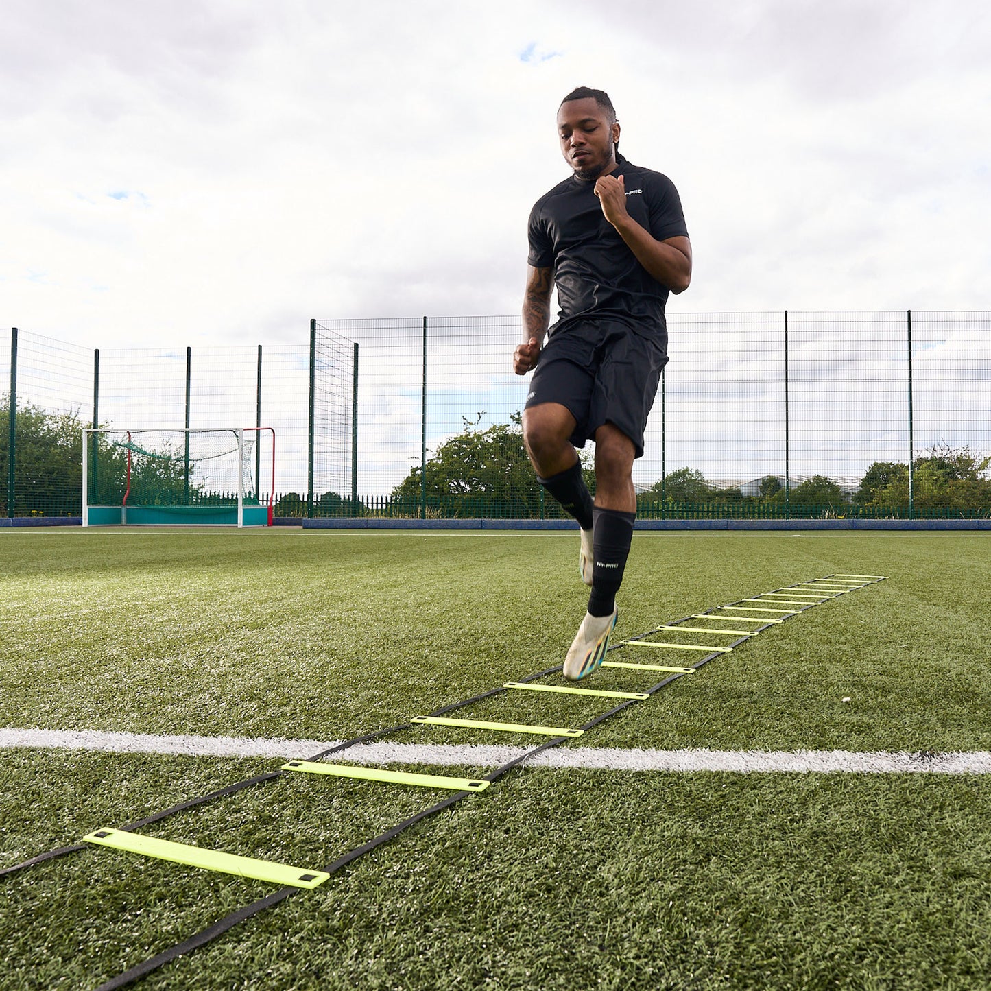 Hy-Pro Sports yellow agility ladder being used by a footballer on a football pitch