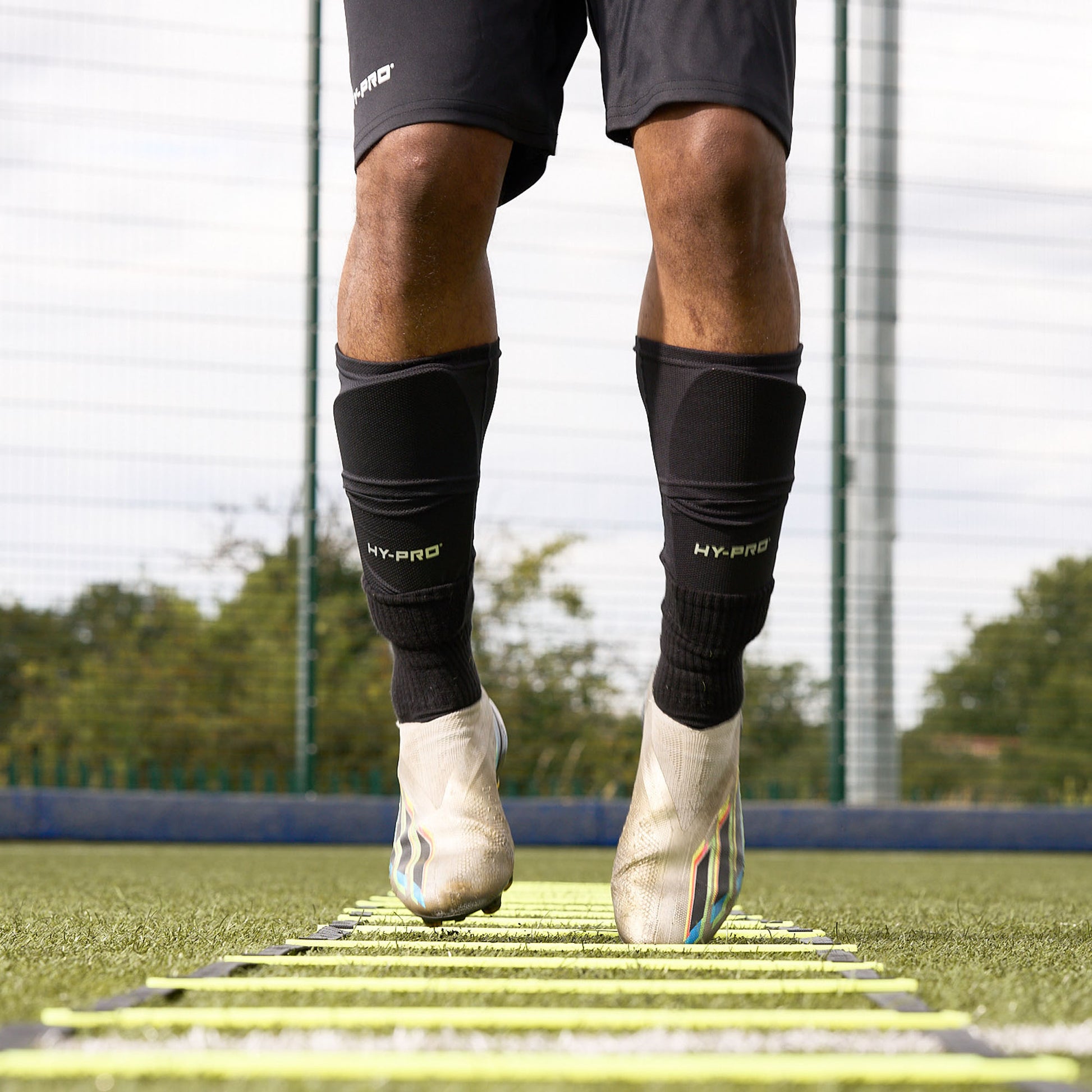 Close up of feet jumping as they are using the Hy-Pro Sports yellow agility ladder