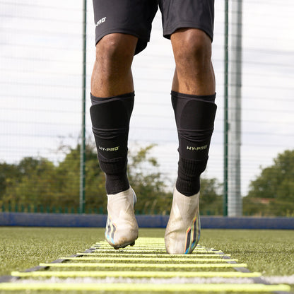 Close up of feet jumping as they are using the Hy-Pro Sports yellow agility ladder