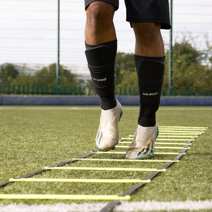 Close -up of feet using the Hy-Pro Sports yellow agility ladder