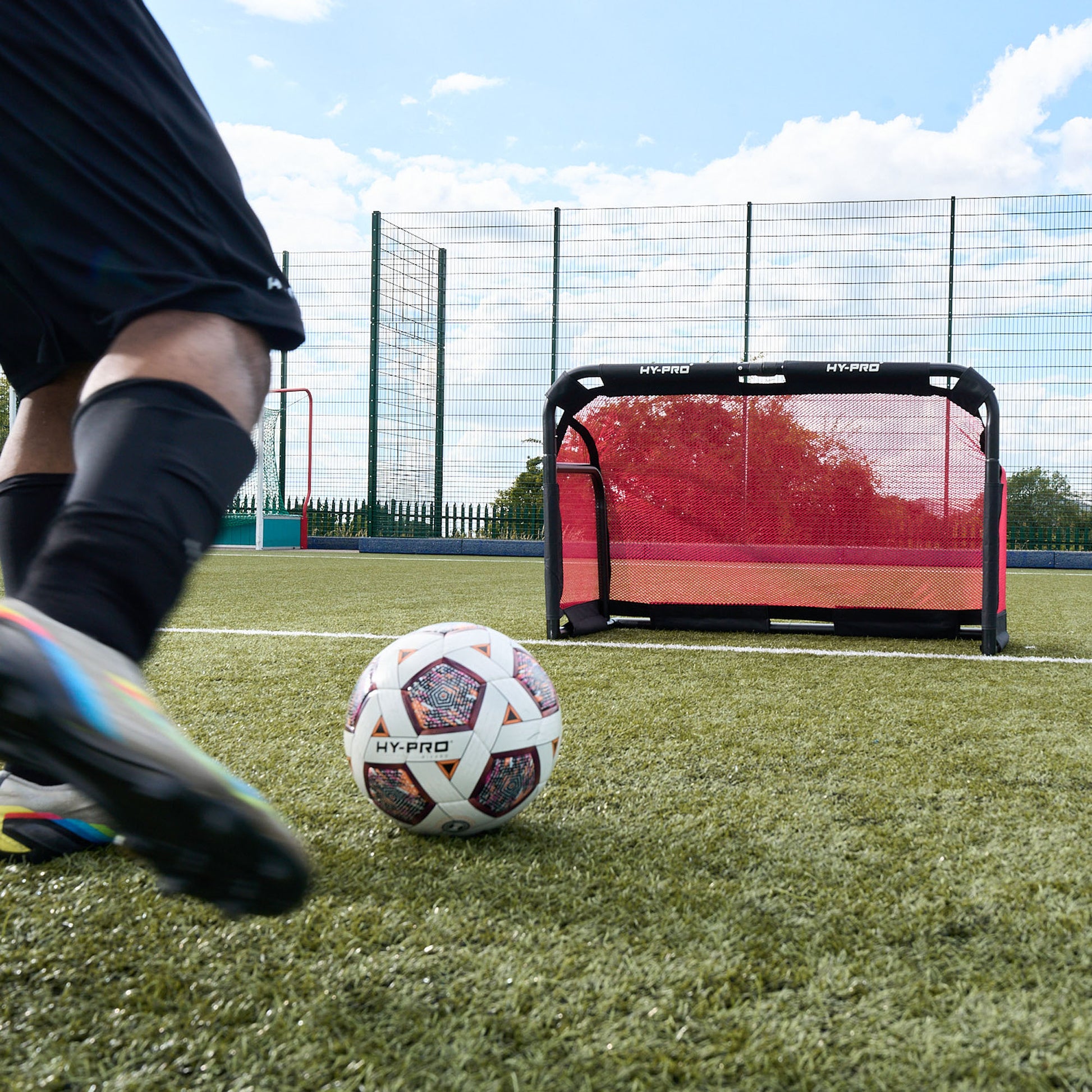 Hy-Pro Official FIFA Quality Approved, Match, Size 5 Football ball being kicked towards the Hy-Pro Sports 3V3 collapsible football goal