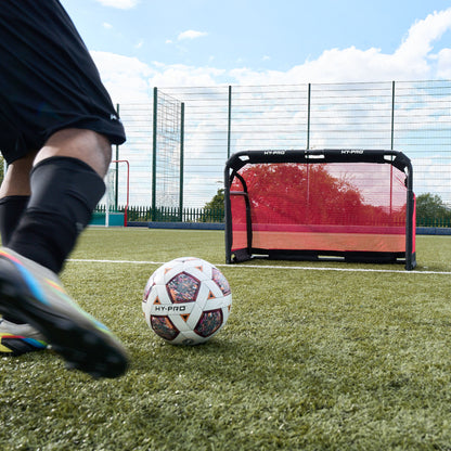 Hy-Pro Official FIFA Quality Approved, Match, Size 5 Football ball being kicked towards the Hy-Pro Sports 3V3 collapsible football goal