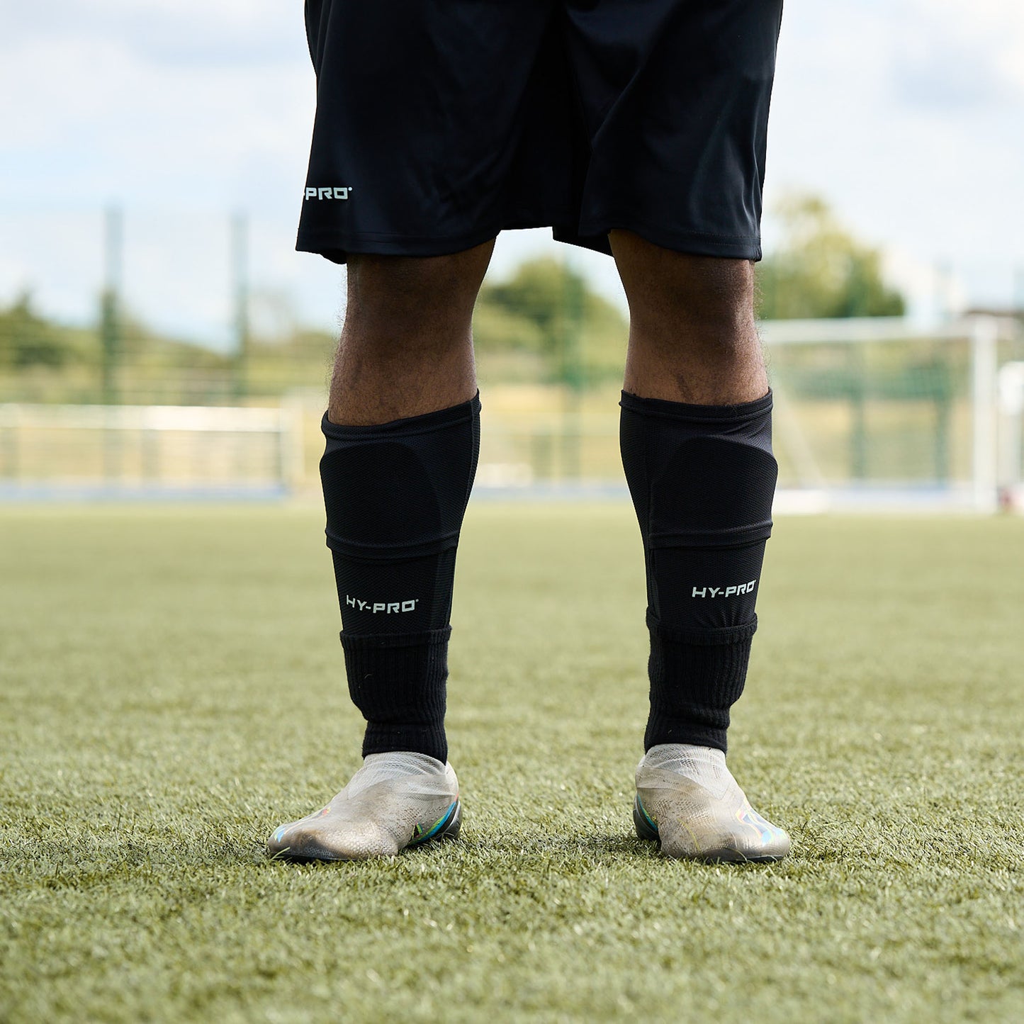 Close up of Hy-Pro Sports Shin Pads being worn by a football player on a grass pitch
