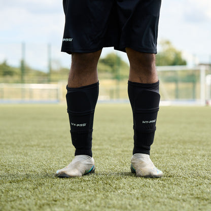 Close up of Hy-Pro Sports Shin Pads being worn by a football player on a grass pitch