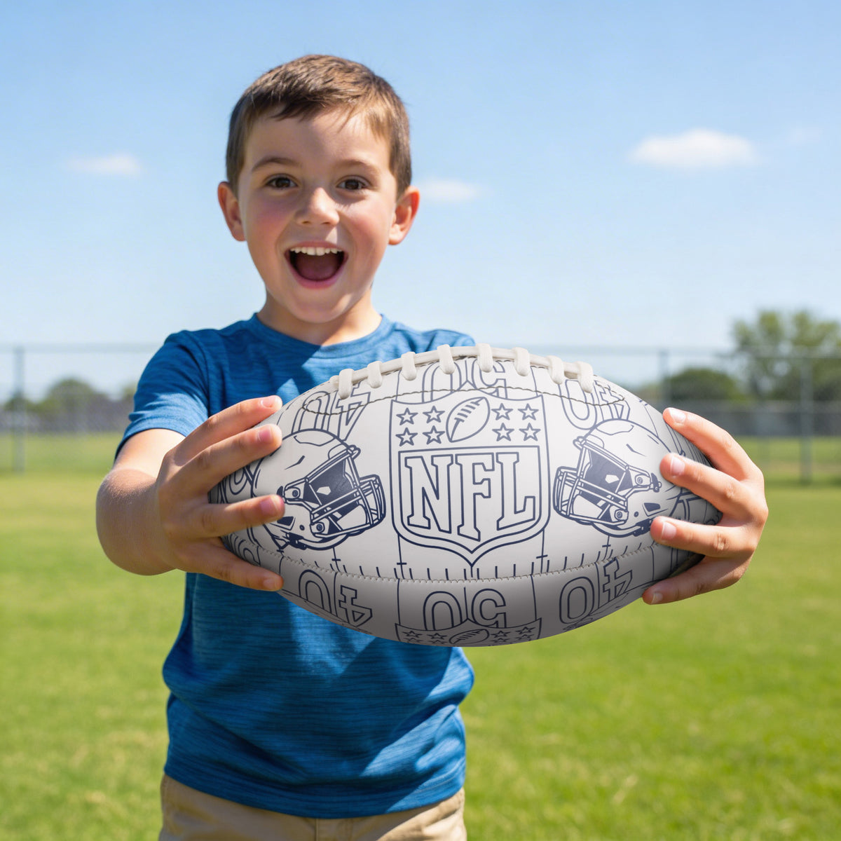 Colour in American football with NFL logo being held by a young oy on a grass field