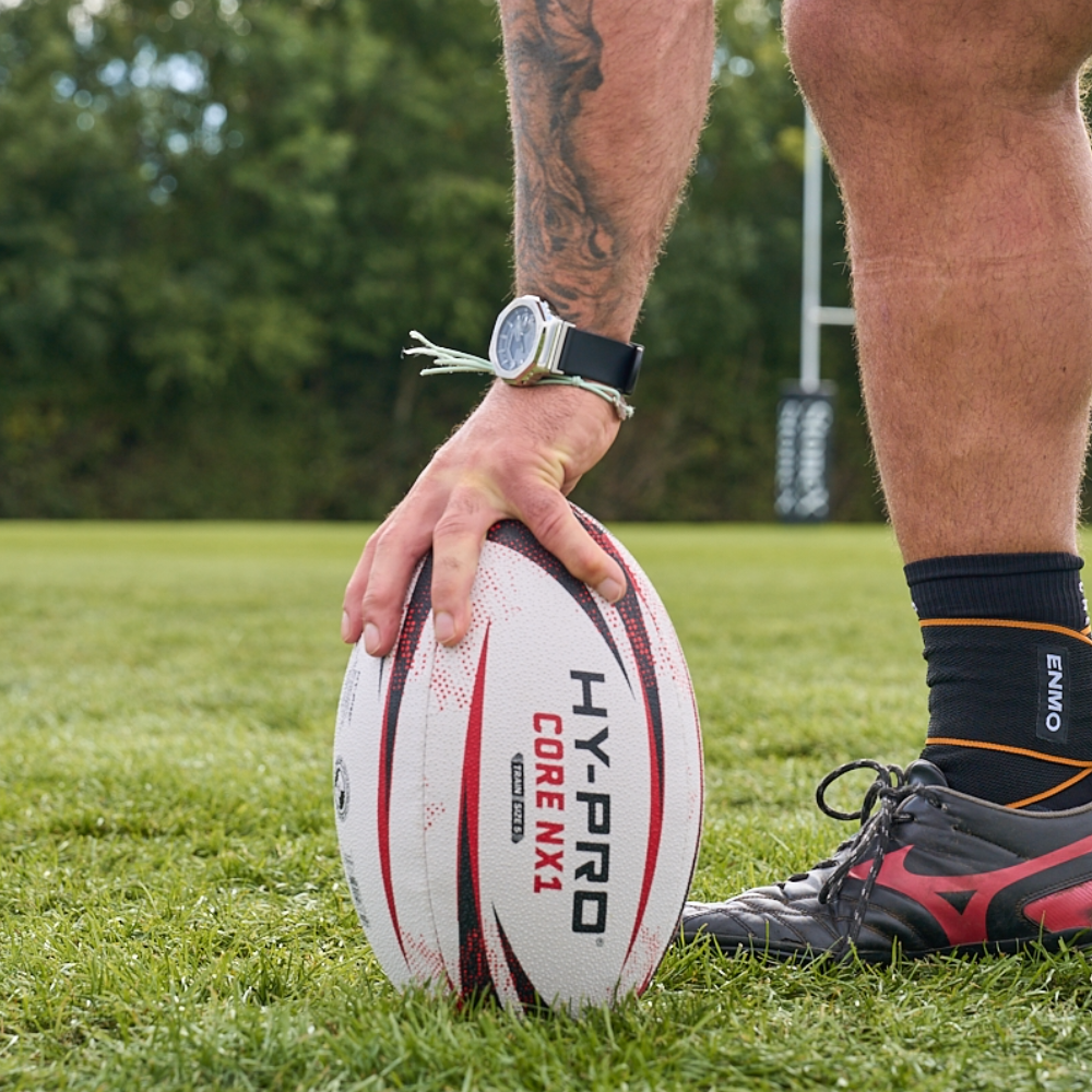 Hy-Pro Core NX1 match rugby ball on a grass pitch being used by a saracens rugby player 
