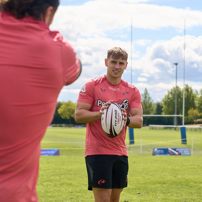 Saracens rugby player catching the Hy-Pro Core NX1 match rugby ball on a grass rugby pitch 
