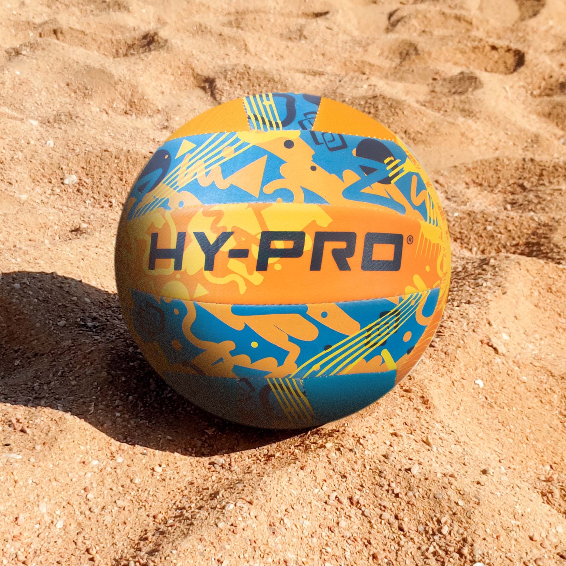 Hy-Pro Neoprene Volleyball with bright colourful design and HY-PRO logo on the beach