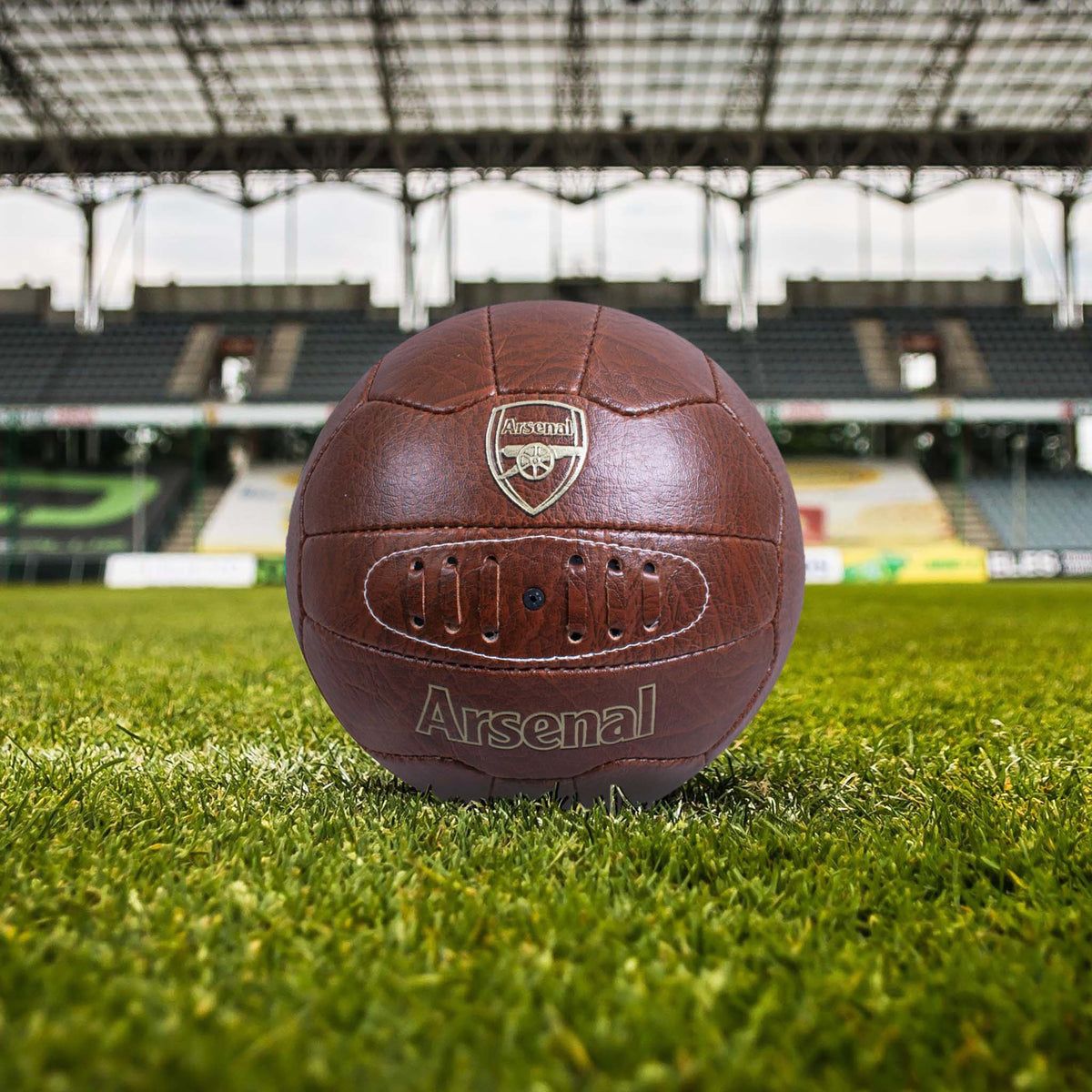 Arsenal Faux Leather Retro Football on a grass football stadium background